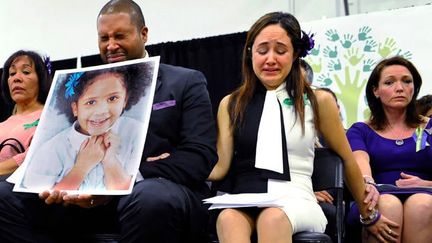 Jimmy Greene, foreground left, Nelba Marquez-Greene, center, parents of Sandy Hook Elementary School shooting victim Ana Marquez-Greene, and Nicole Hockley, right, mother of victim Dylan Hockley, react during a news conference at Edmond Town Hall in Newto