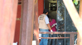 Police investigators work to obtain fingerprints on a door at the home where masked, armed men broke in, in Acapulco, Mexico, Tuesday Feb. 5, 2013. According to the mayor of Acapulco, five masked men burst into this house that Spanish tourists had rented on the outskirts of Acapulco, in a low-key area near the beach, and held a group of six Spanish men and one Mexican woman at gunpoint, while they raped the six Spanish women before dawn on Monday.