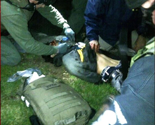 Dzokhar Tsarnaev lies on the ground after being detained by federal agents on Friday, April 19, 2013