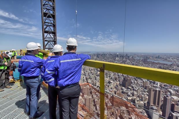 Scott Pelley visits the top of One World Trade before it was crowned with the final piece of the spire.