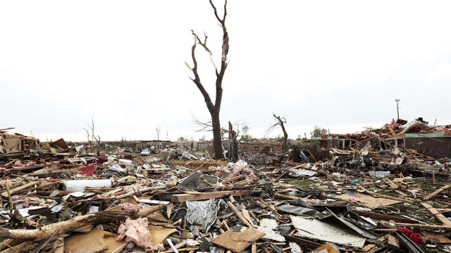 Massive piles of debris cover ground after powerful tornado ripped through Moore, Oklahoma on May 20, 2013 