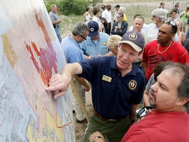 Incident Commander Rich Harvey, center, gives an update on the Black Forest Fire, to residents during a press briefing in Colorado Springs, Colo., on June 14, 2013.