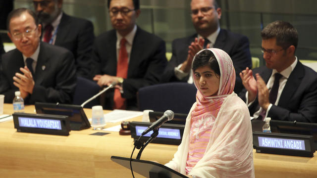 United Nations Secretary-General Ban Ki-moon, left, applauds as Malala Yousafzai, right, addresses the â 