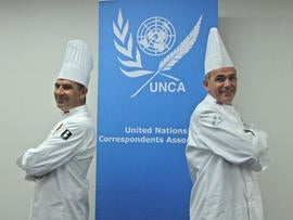 Chef Christian Garcia, left, who serves Prince Albert II of Monaco and as president of Club des Chefs des Chefs, and chef Mark Flanagan, who serves Britain's Queen Elizabeth II and as the group's vice president, pose at United Nations headquarters in New York July 29, 2013.