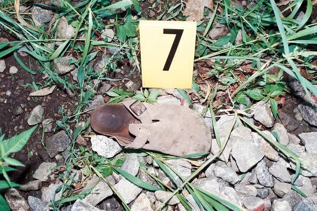 One of Holly's sandals lays in the ditch near the railroad tracks where Resendiz brutally attacked her and Chris. After waking up after the attack, Holly walked barefoot over rocks and broken glass on the tracks to get to a house seeking help. 