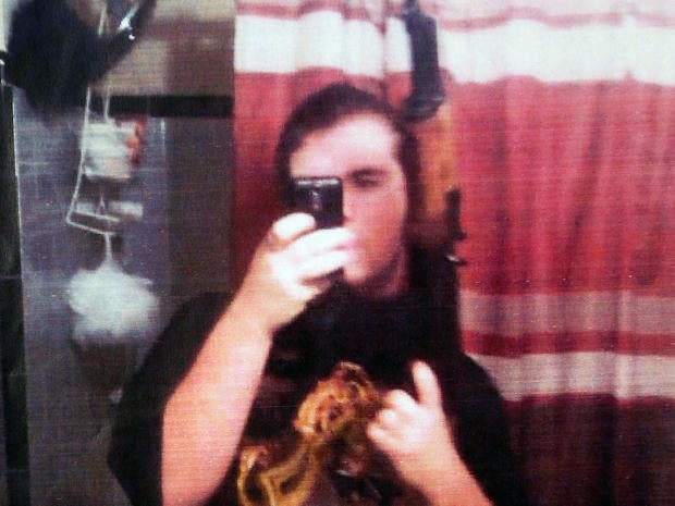 Michael Brandon Hill poses in this undated photo provided by the Dekalb County Police Department with an AK-47-style rifle that authorities believed is the one he had when he was arrested at a Decatur, Ga., elementary school Aug. 20, 2013.