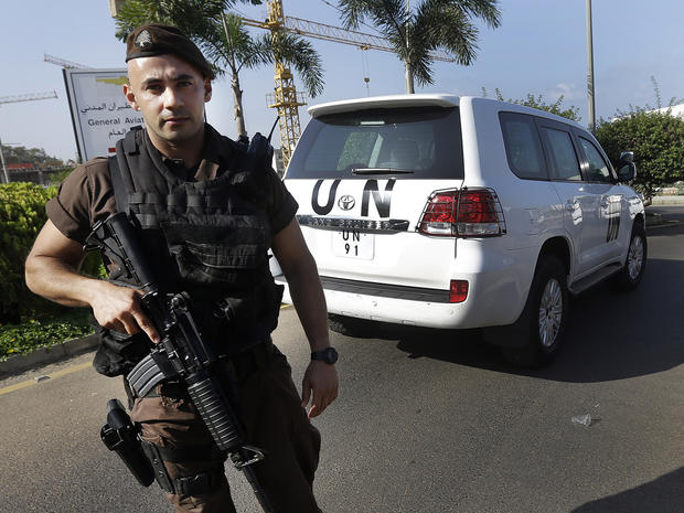 A Lebanese special forces policeman escorts the vehicles of U.N. experts upon their arrival at the private jet terminal at Beirut's international airport Aug. 31, 2013. 