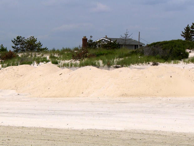 While some coastal towns say dunes offered protection, others say they wouldn't have stopped the Superstorm Sandy's massive surge.