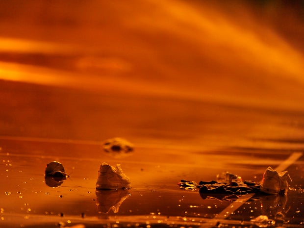 Shoes are left behind at the crime scene Sept. 20, 2013, where a number of people, including a 3-year-old boy, were shot overnight in a city park in Chicago. 