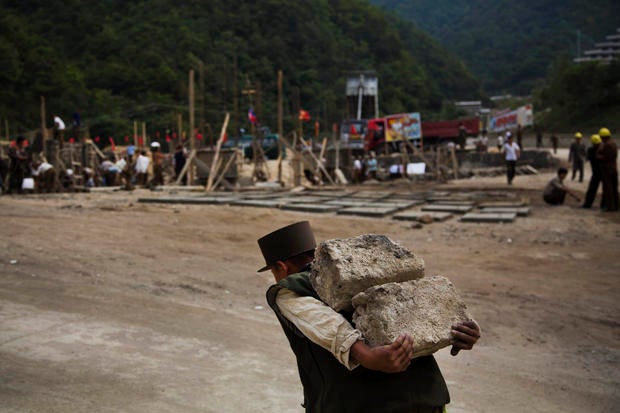 North Korean construction worker carries bricks at a building project to construct a ski resort at North Korea's Masik Pass.