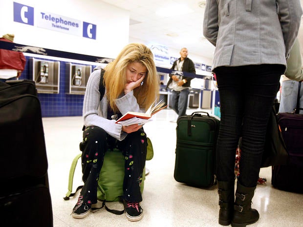 Jamie Collier, 18, is engrossed in her book while waiting to board her bus at the Raleigh Greyhound Station in downtown Raleigh, N.C., Nov. 26, 2013.