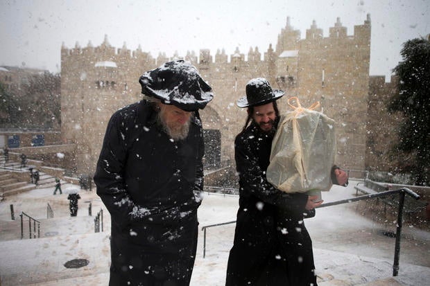 Ultra orthodox jews walk past the Damascus gate outside Jerusalem's old city
