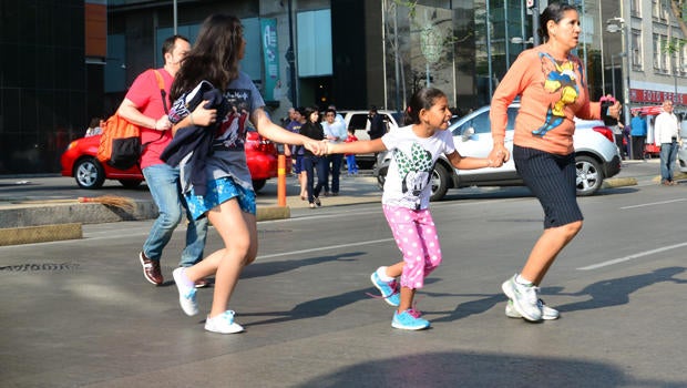 People evacuate buildings after a strong earthquake rattled Mexico City April 18, 2014.