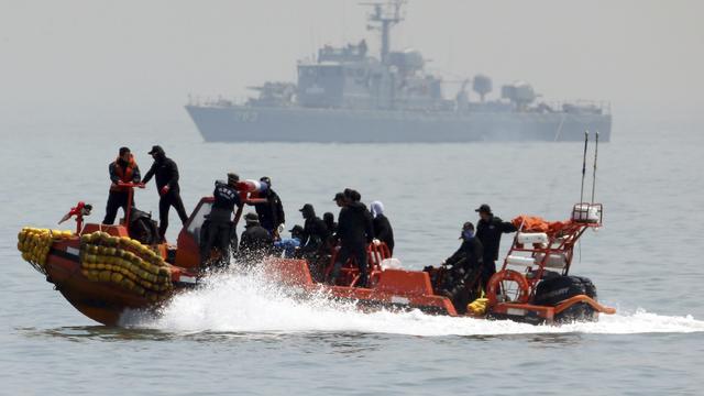 South Korean rescue workers operate around the area where capsized passenger ship Sewol sank 