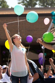 Cassidy Stay, lone survivor of the mass shooting of her parents and siblings, lets a balloon go during a community memorial celebrating the lives of the Stay family at Lemm Elementary School July 12, 2014, in Spring, Texas.
