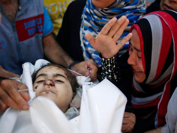 Relatives of Palestinian girl Layan al-Silk, whom medics said was killed with other family members by Israeli shelling at a market in Gaza City's Shijaiyah district, mourn during her funeral