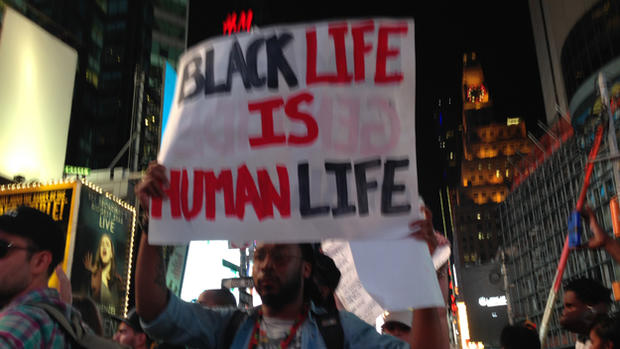 Man holds sign during Michael Brown protest 