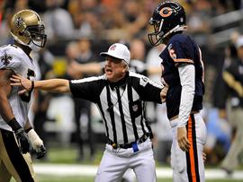 Referee Walt Coleman breaks up two players on the field. (CBS News)