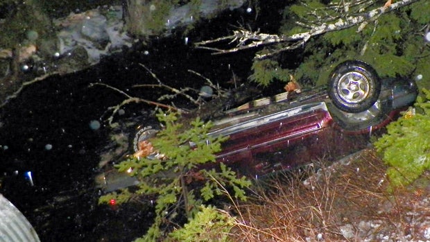 An SUV rests upside down in water alongside Route 6 in Kossuth Township, Maine, after Stephen McGouldrick lost control of it on the icy road Nov. 17, 2014, in this picture provided by the Maine State Police.