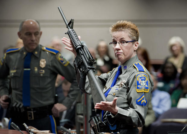 In this Jan. 28, 2013, file photo, firearms training unit Detective Barbara J. Mattson, of the Connecticut State Police, holds up a Bushmaster AR-15 rifle, the same make and model of gun used by Adam Lanza in the Sandy Hook School shooting, for a demonstr 