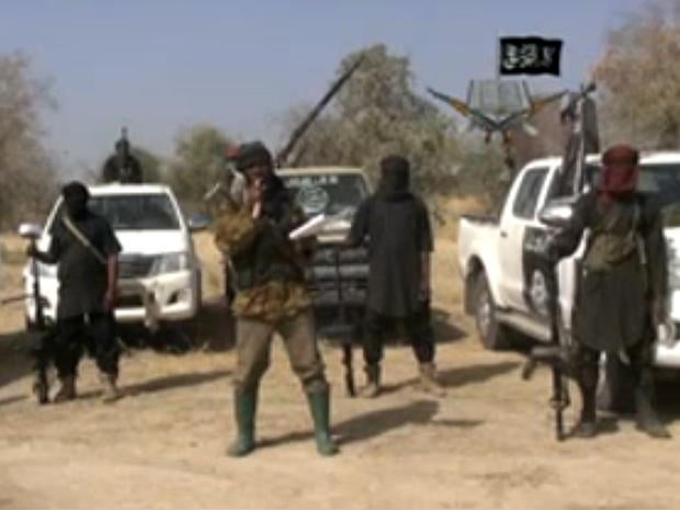Boko Haram militants, and at center, the man claiming to be the group's leader, Abubakar Shekau, appear in a propaganda video