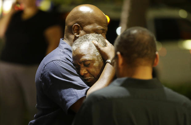 Worshippers embrace following group prayer across street from scene of shooting in historic black church on night of June 17, 2015, in Charleston, S.C. 