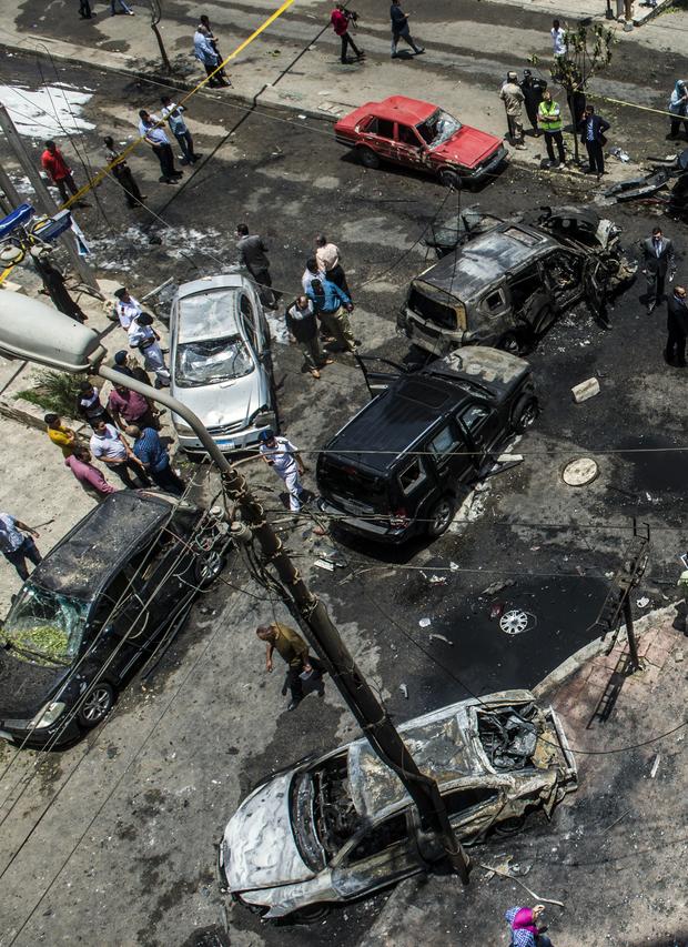 Egyptian security forces stand guard at the site of a bomb that targeted the convoy of the Egyptian state prosecutor, Hisham Barakat, in the capital Cairo