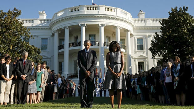 President Obama and first lady Michelle Obama observe a moment of silence on the South Lawn of the White House to mark the 14th anniversary of the 9/11 attacks in Washington Sept. 11, 2015.