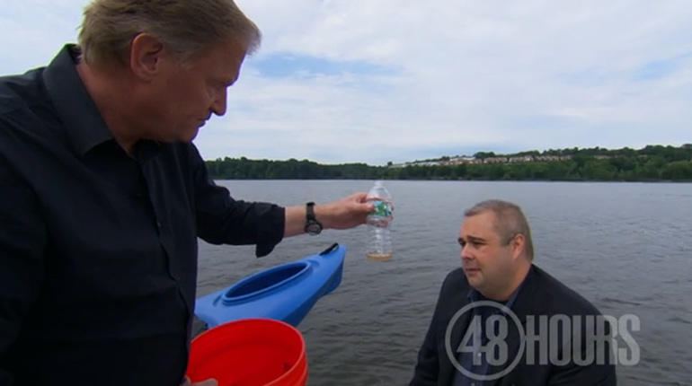 Peter Van Sant holds a bottle with the amount of water drained from the kayak's drain plug opening 