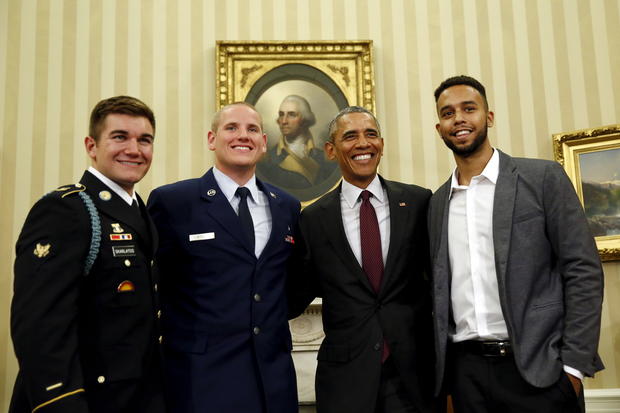 President Obama poses for pictures with Spencer Stone, 2nd left, Anthony Sadler, right, and Alek Skarlatos, left, the three men who subdued a gunman on a Paris-bound train in August, at the Oval Office at the White House in Washington Sept. 17, 2015.