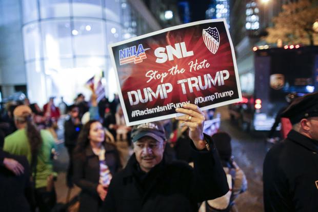 People protest in front of NBC studios Nov. 4, 2015, in New York, calling for the network to rescind its invitation to Donald Trump to host "Saturday Night Live" on Nov. 7, 2015. 