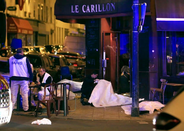 Victims lay on the pavement in a Paris restaurant Nov. 13, 2015. Police officials in France reported a shootout in a Paris restaurant and an explosion in a bar near a Paris stadium.