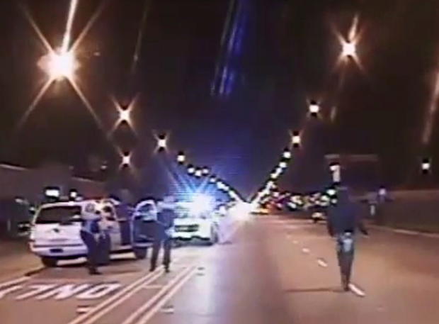 Laquan McDonald, right, walks on a road before he was shot 16 times by police officer Jason Van Dyke in Chicago in this still image taken from a police vehicle dash camera video shot on Oct. 20, 2014, and released by Chicago police on Nov. 24, 2015.