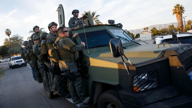 Law enforcement officers search for the suspects of a mass shooting Dec. 2, 2015, in San Bernardino, California.