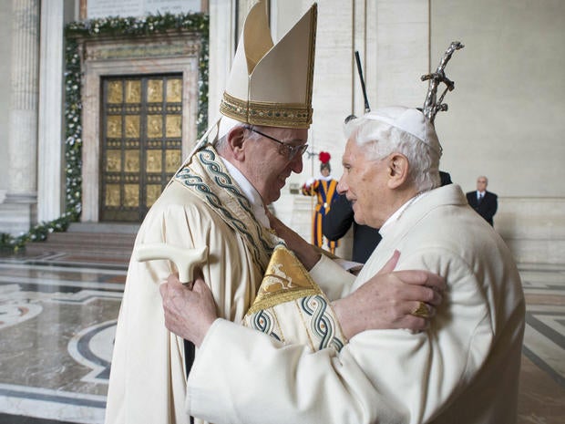 Pope Francis (L) embraces Emeritus Pope Benedict XVI before opening the Holy Door to mark opening of the Catholic Holy Year, or Jubilee, in St. Peter's Basilica