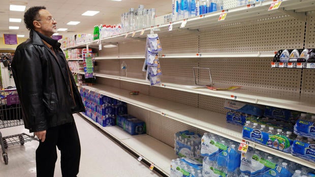 A shopper looks at the bottled water section at a supermarket on Jan. 21, 2016, ahead of an expected blizzard in Washington, D.C.