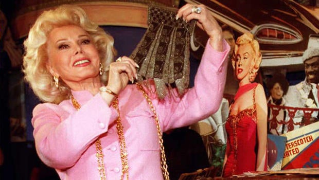Actress Zsa Zsa Gabor holds up a beaded purse removed from a 30-year-old trunk containing possessions from actress Marilyn Monroe on April 11, 1996, at Planet Hollywood in Beverly Hills, California.