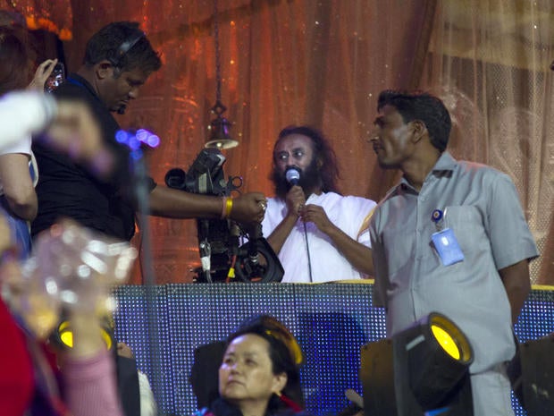 Indian spiritual guru Sri Sri Ravishankar (center) addresses followers at a festival on the banks of the Yamuna River in New Delhi, India