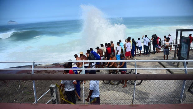 People look below after a recently inaugurated bicycle lane collapsed in Rio de Janeiro, Brazil, on April 21, 2016.