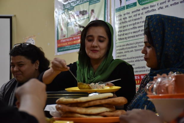 Ilham interpreter and employee Zoha (center), who always wanted to be a journalist to tell "real stories" of Afghanistan, with UNHCR coordinator Aditi Sabbarwal (left) and other Ilham member Ziaul