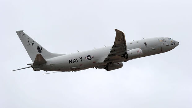A U.S. Navy P-8 Poseidon aircraft flies out from Perth International Airport to assist with the international search effort trying to locate missing Malaysia Airways Flight 370 on April 16, 2014, in Perth, Australia.
