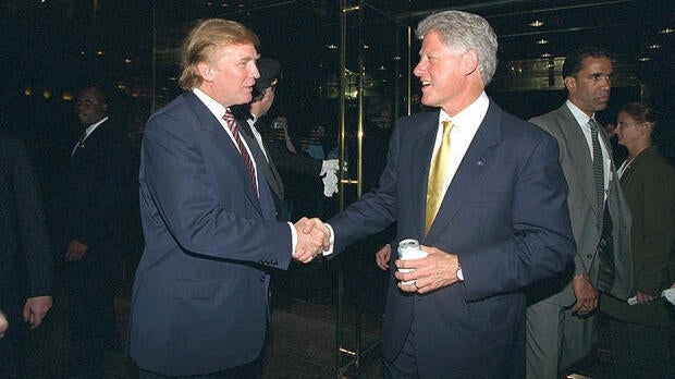 Donald Trump and President Clinton shake hands at a fundraiser at Trump Tower in New York on June 16, 2000.