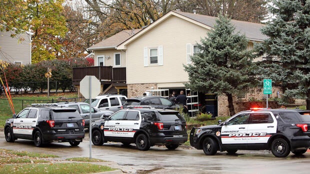 Urbandale police officers gather outside the home of Scott Michael Greene, the suspected gunman of two police officers who were shot and killed in separate attacks described as “ambush-style” in Urbandale and Des Moines, Iowa, Nov. 2, 2016.