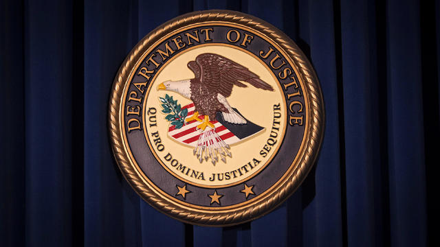 The Department of Justice logo is pictured on a wall after a news conference in New York Dec. 5, 2013. 