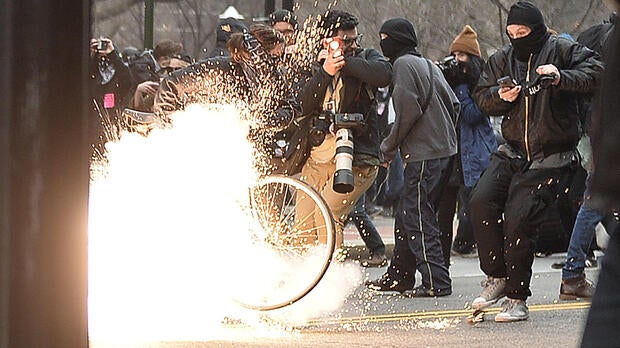 A police flash-bang grenade explodes as officers clash with protesters after the inauguration of President Trump on Jan. 20, 2017, in Washington.