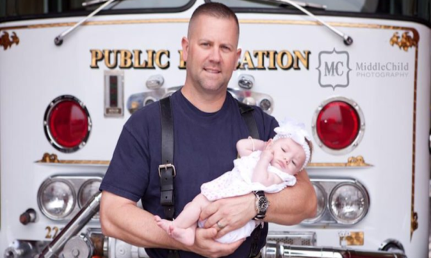 Marc Hadden poses with his newborn daughter, Gracie, shortly after her adoption. 