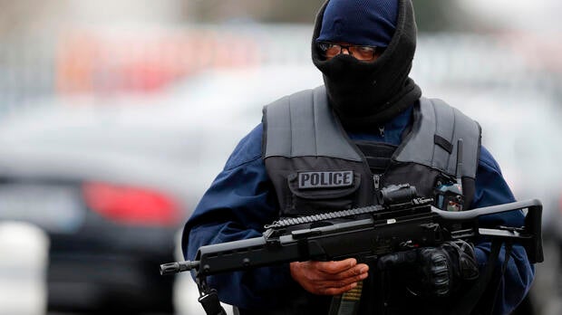 A French policeman secures the area at Paris’ Orly airport on March 18, 2017, following the shooting of a man by French security forces.