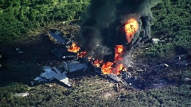 Smoke and flames rise from a military plane that crashed in a farm field in Itta Bena, Miss., July 10, 2017, in this frame from video.