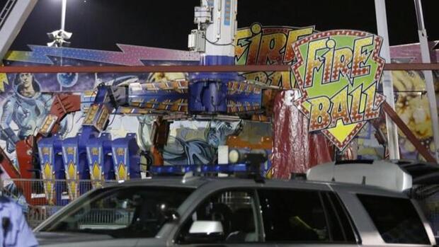 Authorities stand near the Fire Ball amusement ride after the ride malfunctioned at the Ohio State Fair July 26, 2017, in Columbus, Ohio.