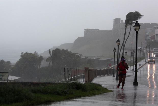 A woman runs in the rain as Hurricane Irma slammed across islands in the northern Caribbean on Wednesday, in San Juan 